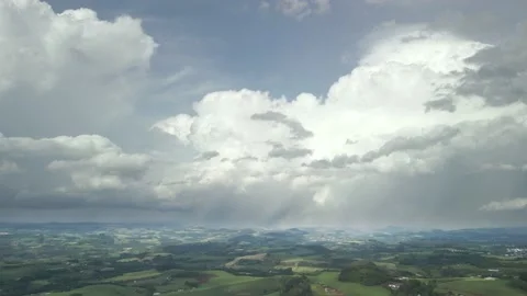 Flying over beautiful green fields with great clouds ahead. Stock Footage 234457513