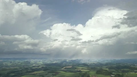 Flying over beautiful green fields with great clouds ahead. Stock Footage 234457656