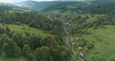 Flying over a beautiful green forest in a mountain landscape Stock Footage 128697211