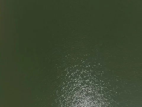 Flying over beautiful green waves sparkling in sunlight. 4K Stock Footage 75425070