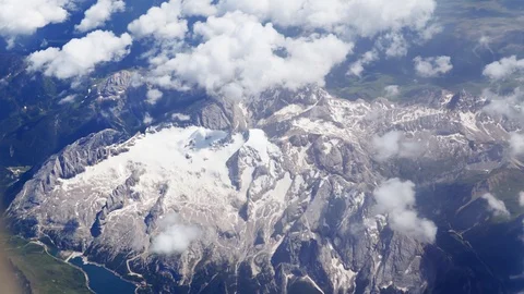 Flying over beautiful snow-capped peaks surrounded by green valleys with lakes Stock Footage 92991470