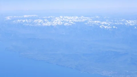 Flying over beautiful snow-capped peaks near Bay of Biscay - view from airplane Stock Footage 103153757