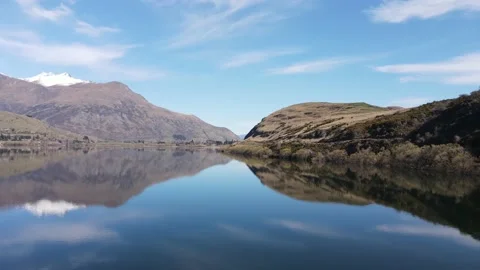 Flying over beautiful still lake - Queenstown, New Zealand Stock Footage 139959306