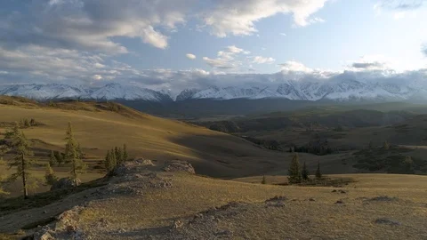 Flying over beautiful sunset landscape with mountains, trees and hills Stock Footage 122807190