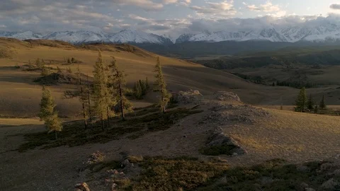 Flying over beautiful sunset landscape with mountains, trees and hills Stock Footage 122916522