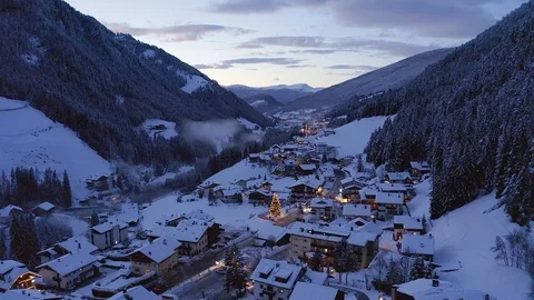 Flying over beautiful winter ski resort town of Val Gardena in Italy, Dolomites 121937898