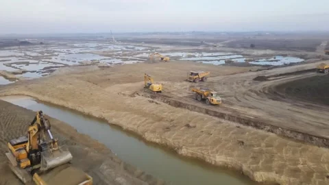 Flying over the big construction site with lot of heavy machinery Stock Footage 293012212