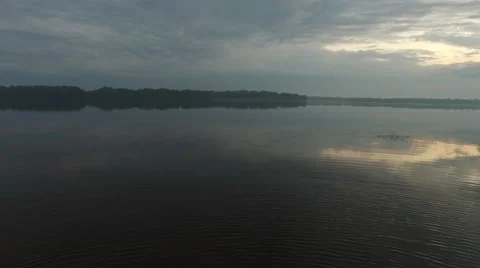 Flying over the big river at dawn Video stock 63488439