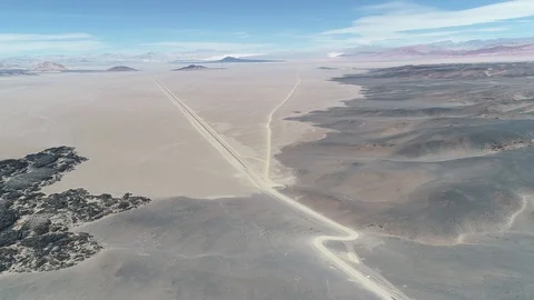 Flying over black bed of lava. Volcanic desertic landscape with various cones Vidéo 103480904