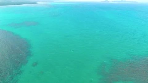 Flying over blue sea water surface, crystal clear water beautifully refracting Stock Footage 135403975