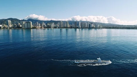Flying over a boat being towed, with Waikiki beach in the background. Video stock 109454609