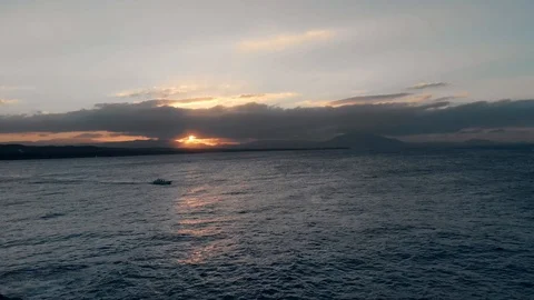 Flying over a boat on a calm ocean and beautiful sunset Stock Footage 101487080