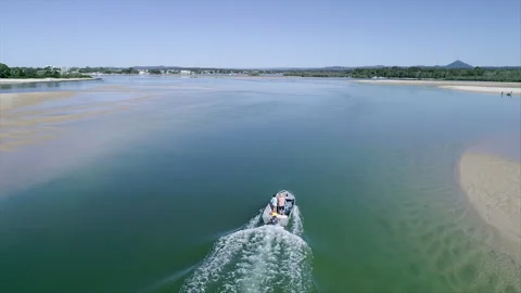 Flying over a boat on a river Stock Footage 291252372