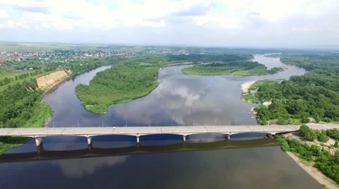 Flying over the bridge across the tranquil river Stock Footage 67876185