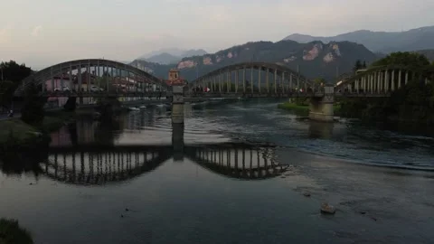 Flying Over Bridge And River Towards a Italian village Stock Footage 160932350
