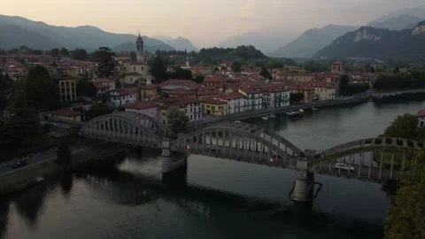 Flying Over Bridge And River Towards a Italian village Stock Footage 160956485