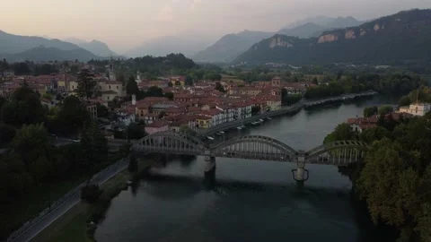 Flying Over Bridge And River Towards a Italian village Stock Footage 160956547