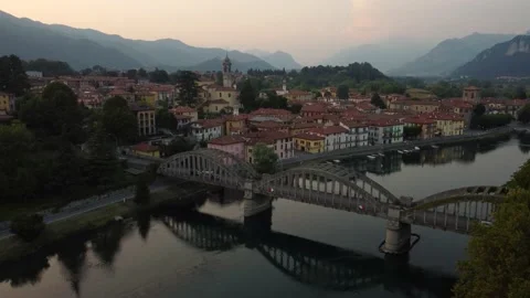 Flying Over Bridge And River Towards a Italian village(U) Stock Footage 161064956