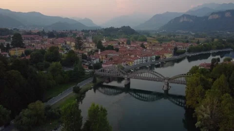 Flying Over Bridge And River Towards a Italian village(U) Stock Footage 161064974