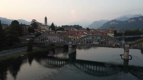 Flying Over Bridge And River Towards a Italian village Stock Footage 161065031