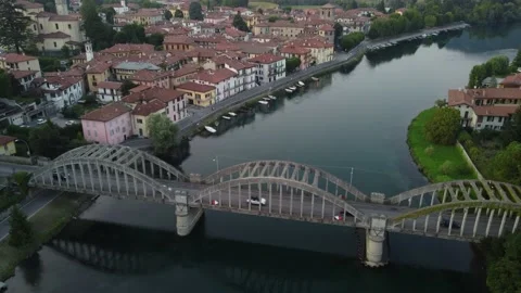 Flying Over Bridge And River Towards a Italian village Stock Footage 161065063