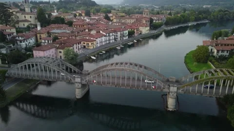 Flying Over Bridge And River Towards a Italian village Stock Footage 161065108