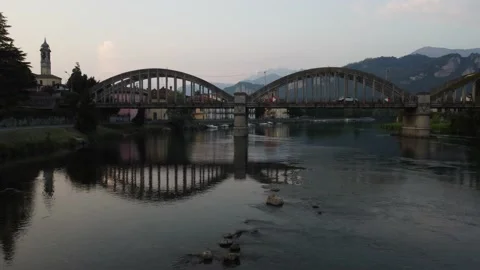 Flying Over Bridge And River Towards a Italian village Stock Footage 161065130