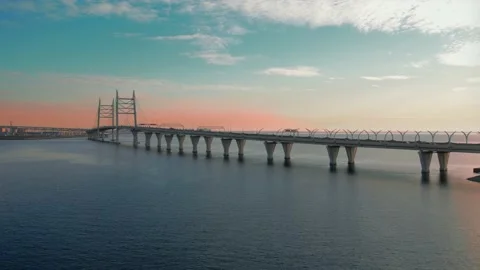 Flying over a bridge over a pond on a quadrocopter at sunset. Stock Footage 182443619