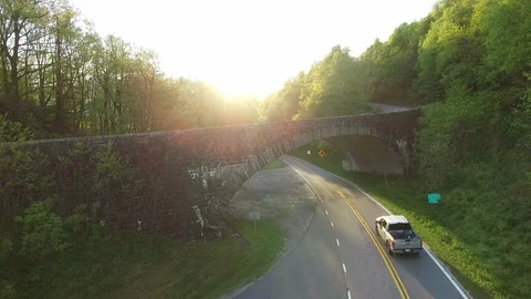 Flying Over a Bridge into the Sunset Stockbeeldmateriaal 128546854
