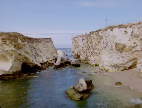 Flying over broken rock formation on California coast 1989 Stock Footage 136070244