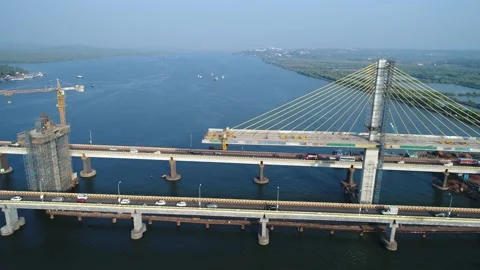 Flying over building a big bridge on Mandovi river, Goa, India. Aerial view. Stock Footage 85533094