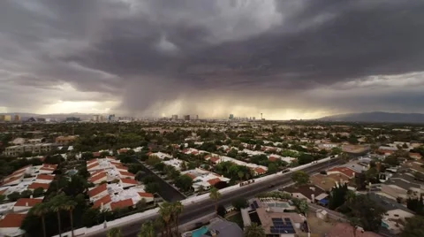 Flying over the buildings during a thunderstorm with a view of Las Vegas Stock Footage 52577264
