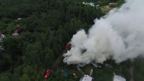 Flying over the burning house in the forest village. Aerial view. Stock-Footage 74853461