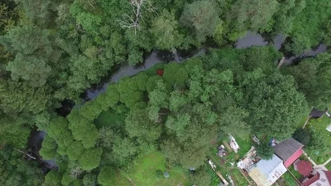 Flying over the burning house in the forest village. Aerial view. 스톡 동영상 74855906