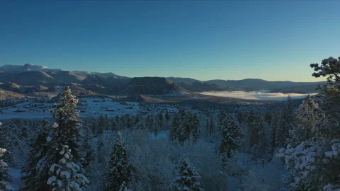 Flying over a cabin to reveal a winter wonderland in Colorado Stock Footage 247364233