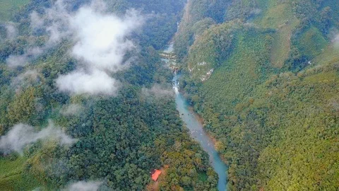 Flying over the Cahabon River and jungle at Semuc Champey, Guatemala, AERIAL Stock Footage 93653448