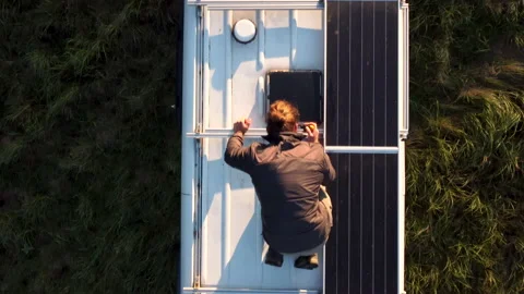 Flying over a camper van with solar panels on the roof Stock Footage 164355975