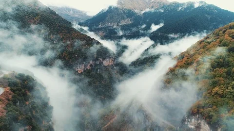 Flying over a canyon in clouds and fog Stock Footage 82077801