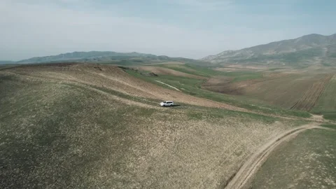 Flying over a car in mountains Video stock 260445124