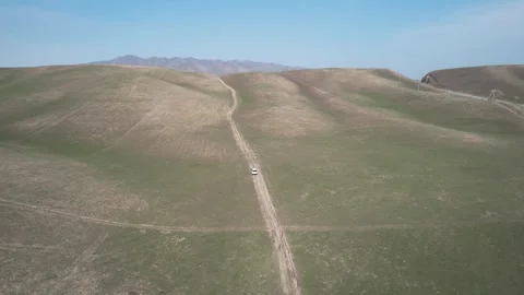 Flying over a car in mountains Video stock 260525585