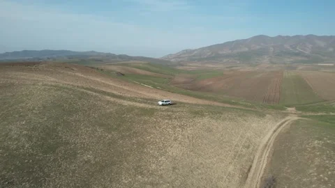 Flying over the car in mountains (raw) Video stock 260445559