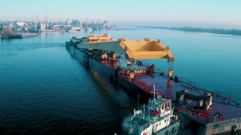 Flying over a cargo ship cruising on the river Stock Footage 159489550