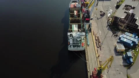 Flying over the cargo ship at the loading pier, aerial view Stock Footage 194019914