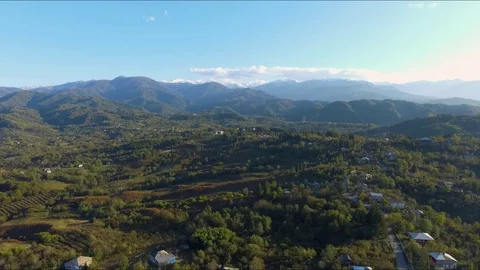 Flying over to charming small village in the valley of Georgian mountains Stock Footage 127828296