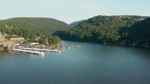Flying over Cheat Lake on a summer evening with boats docked in marina Stock Footage 138386691