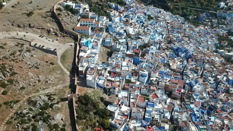 Flying over Chefchaouen and a blue city in Morocco with Drone from above (Aerial Stock Footage 101342820