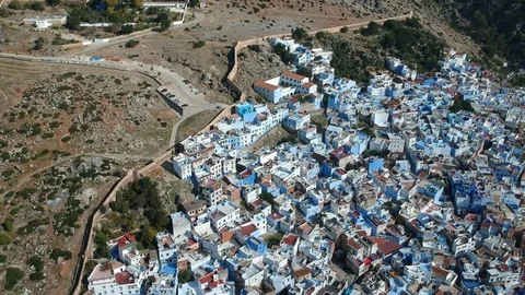 Flying over Chefchaouen and a blue city in Morocco with Drone from above (Aerial Stock Footage 101342978