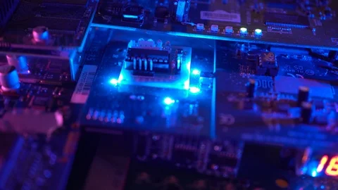 Flying over a circuit board loaded with flashing lights and red digital display Video stock 89090110