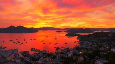 Flying over the city of Coron during a beautiful sunset overlooking the sea Stock Footage 106935127