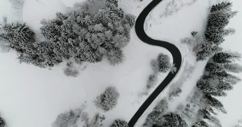 Flying over a clean mountain serpentine surrounded by snow. Stock Footage 92497261